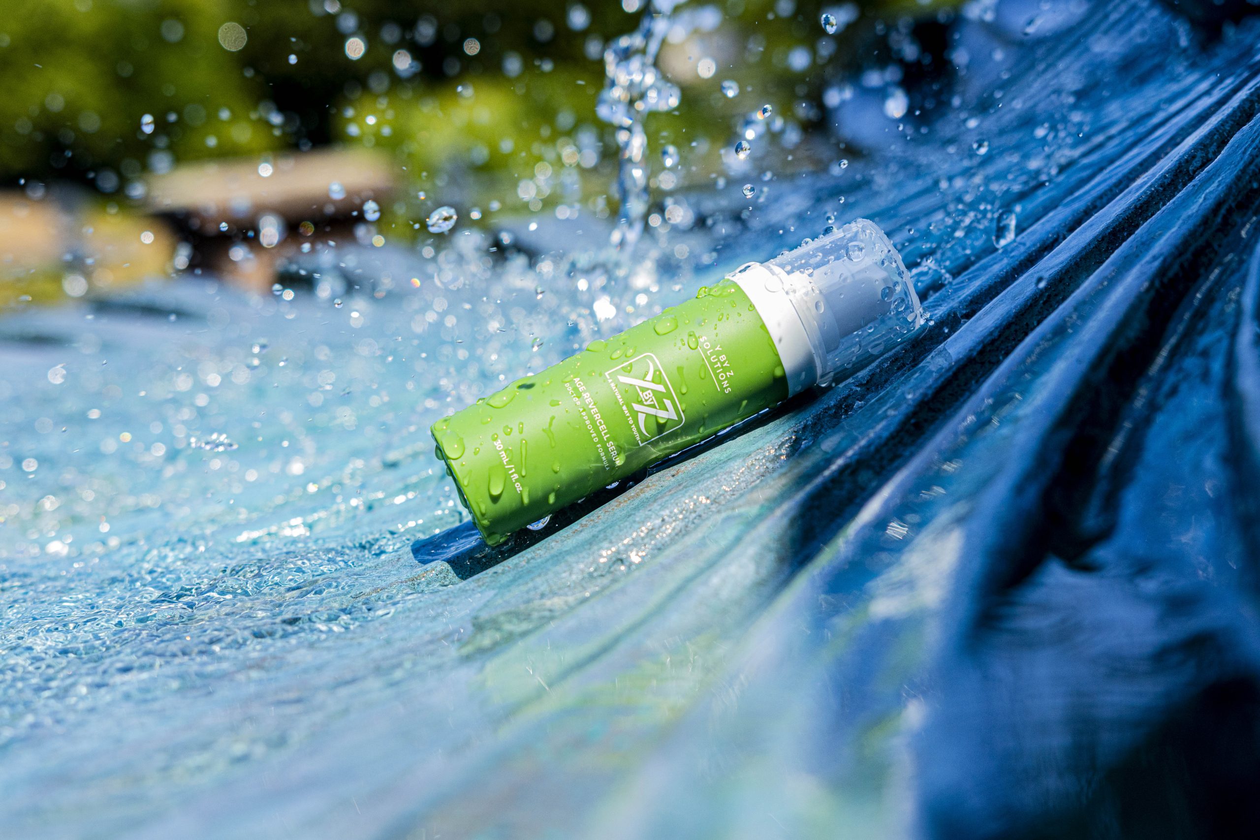 A bottle of sunscreen is sitting on the windshield.